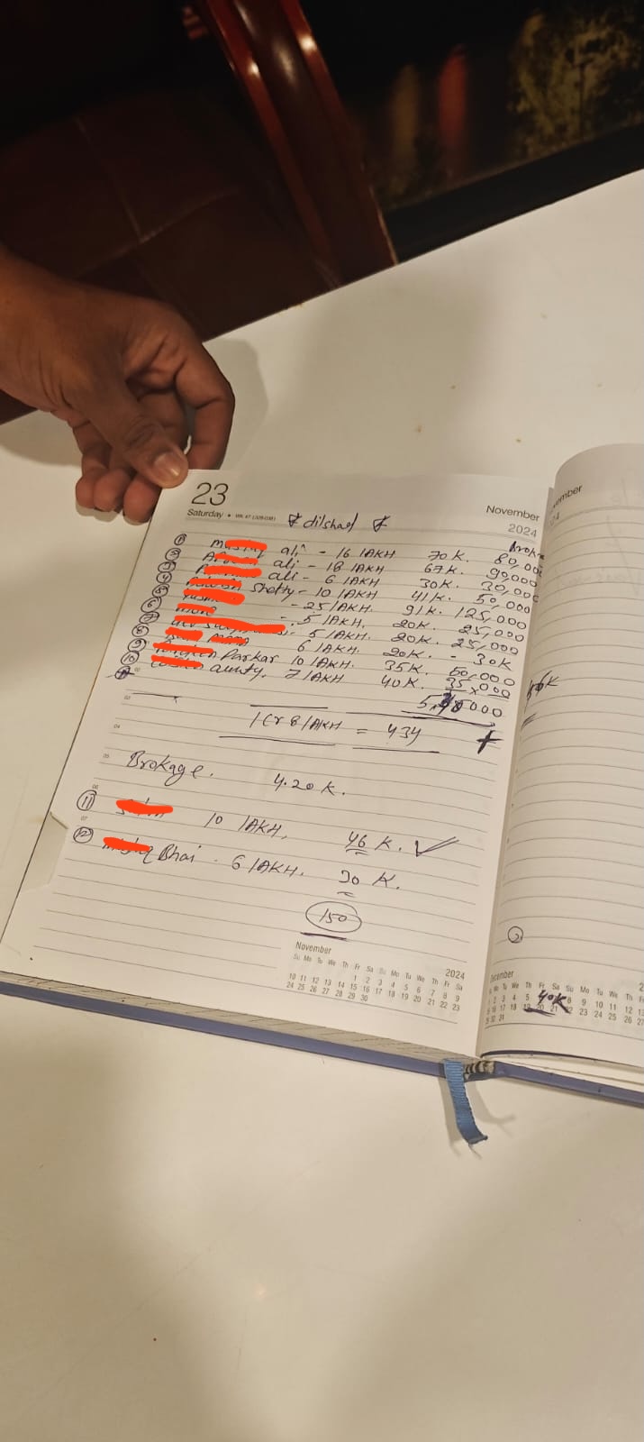 Close-up of a broker’s deposit ledger page with lakh amounts and brokerage notes